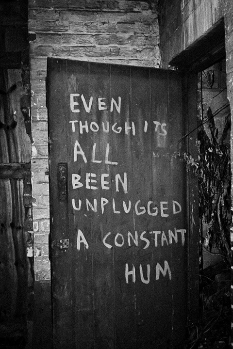 A door with the message: &ldquo;Even though its all been unplugged a constant hum&rdquo; found in a derelict factory
